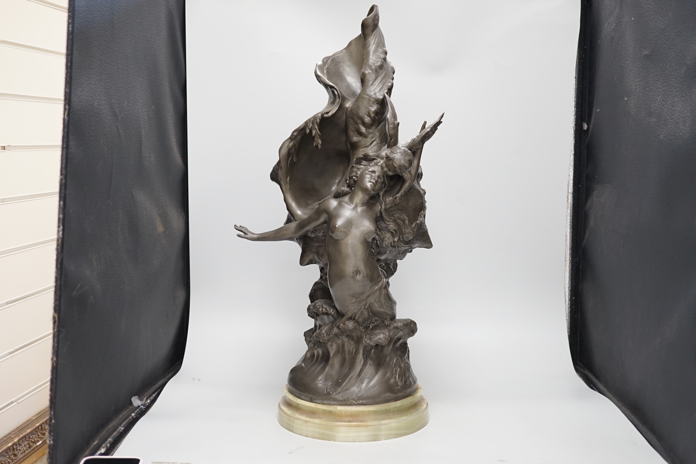 After H. Francois Moreau, a large spelter group of Cupid and a mermaid before a giant conch shell, signed, 64cm high